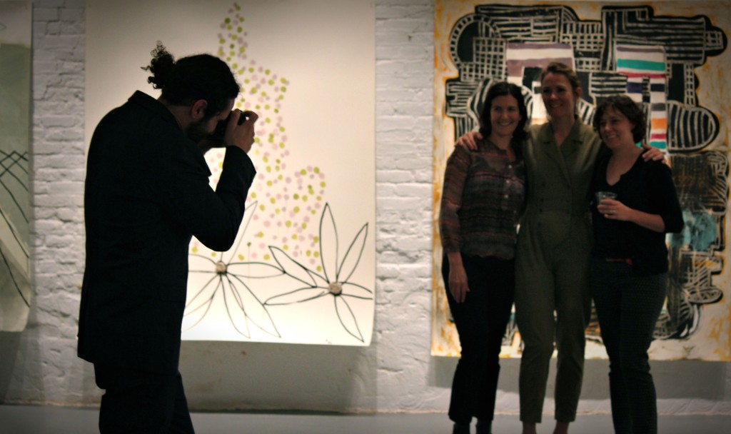Nick De Pirro taking a picture of artists Vicki Sher, Meg Lipke, and Ky Anderson