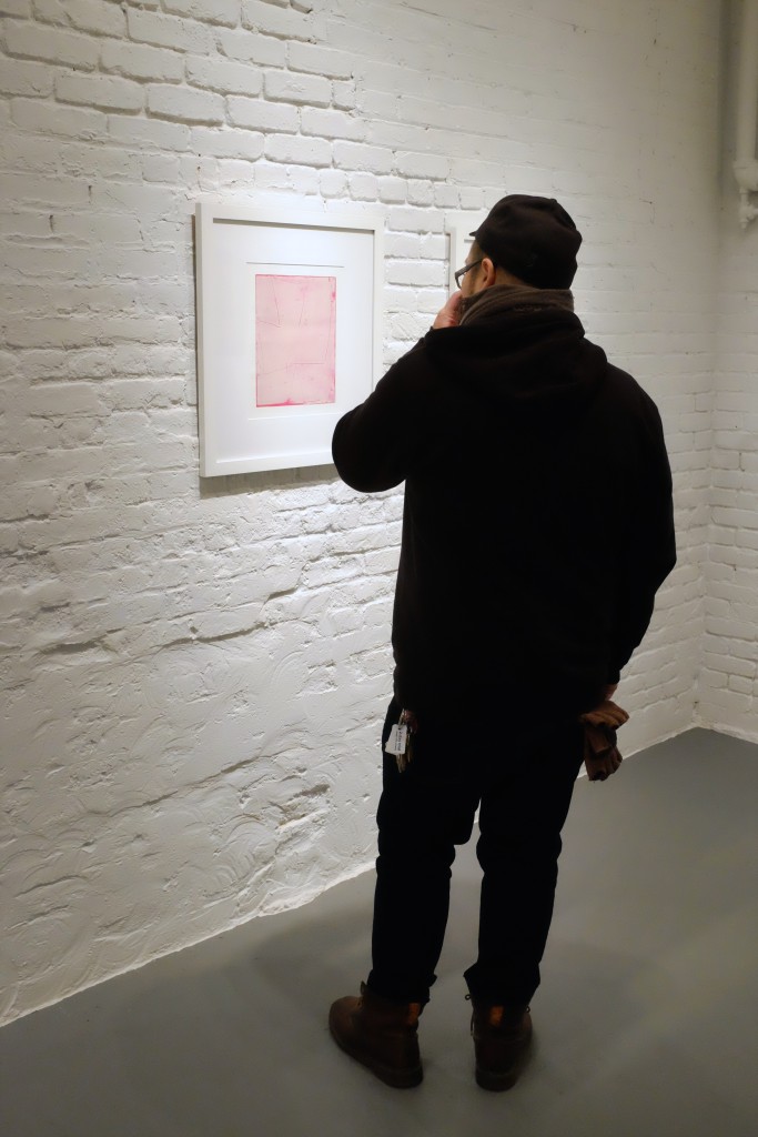 Inspecting work by Jai Llewellyn at PROTO Gallery during the opening reception for PAIR, curated by Ian White Williams