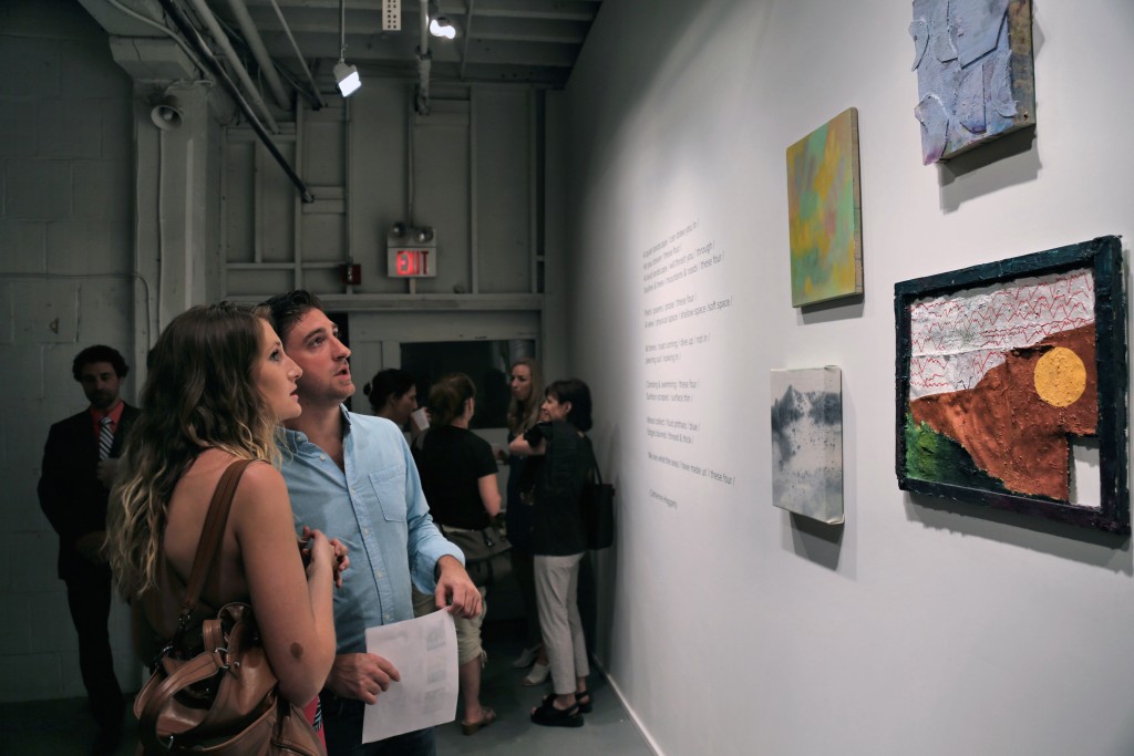 Visitors to PROTO Gallery in the back room checking out work by Yevgeniya Baras, Alan Prazniak, Daniel John Gadd, Dana James, and a poem by curator Catherine Haggarty