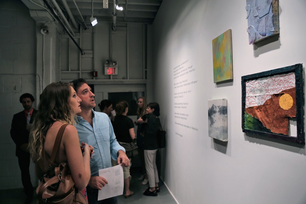 Visitors to PROTO Gallery in the back room checking out work by Yevgeniya Baras, Alan Prazniak, Daniel John Gadd, Dana James, and a poem by curator Catherine Haggarty